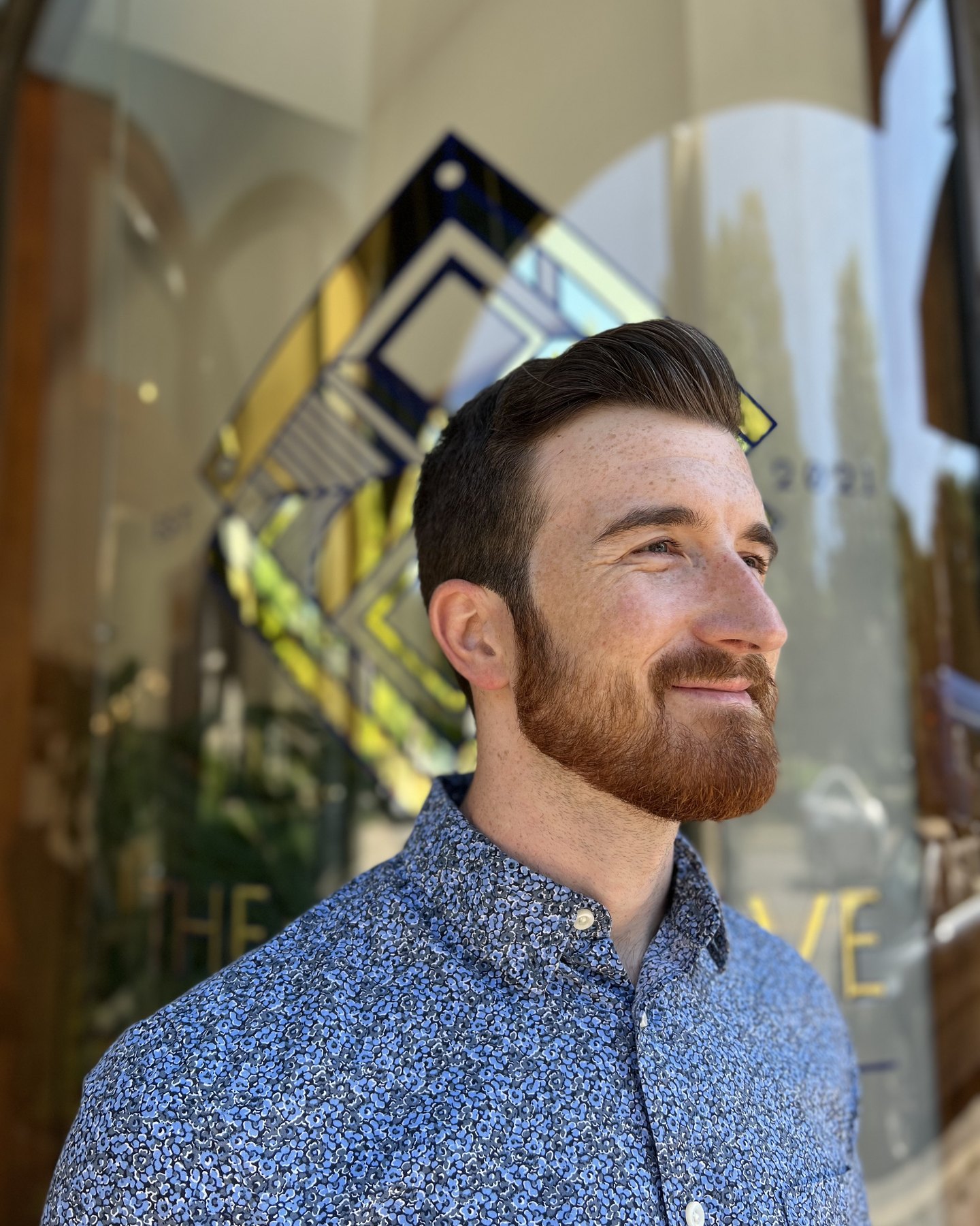Sculpted beard with a combed side part